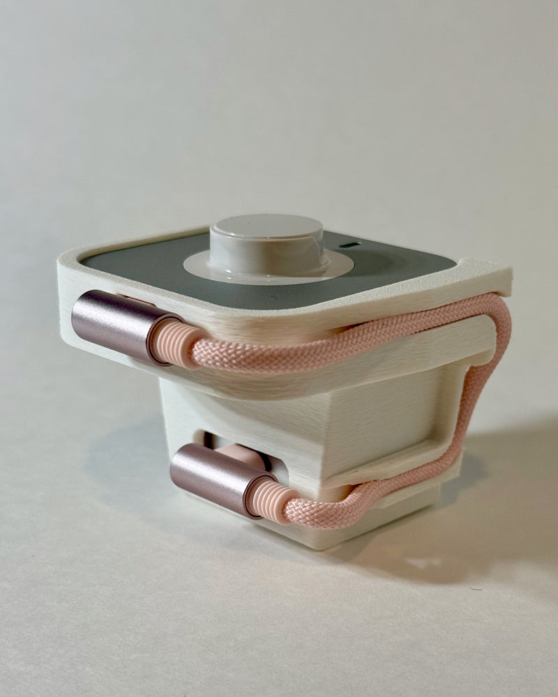 Perch Vertical Oura Ring charging dock in White with a Pink USB-C cable, mounted on a vertical wall outlet